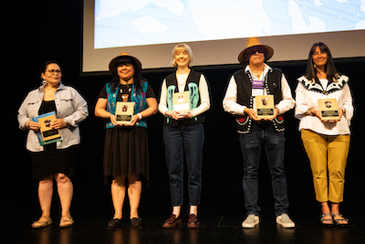 Courtesy of Sealaska Heritage Institute, photo by Stacy Unziker. Caption: Group photo of the awardees who attended SHI’s 2023 Culturally Responsive Education Conference. From left: Naomi Leask; Jennifer McCarty; Donna May Roberts’ granddaughter, Megan Roberts, accepting on Donna’s behalf; Charlie Skultka Jr. and Naomi Michalsen.  Note: Media outlets are permitted to use this image for coverage of this story.
