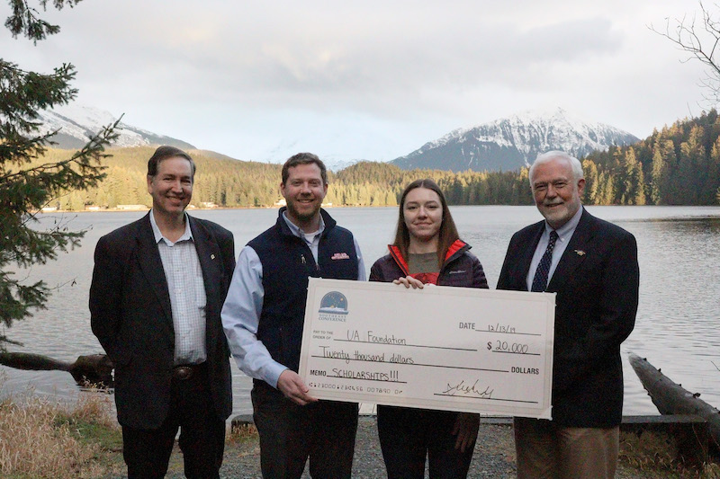 From left: Executive Director of Southeast Conference Robert Venables, VP and Director of Energy Services Alec Mesdag, current scholarship recipient Marina Ogai and Chancellor Rick Caulfield stand by the Auke Lake on the main University of Alaska Southeast campus Friday, Dec 13, 2019 in Juneau, Alaska. (Photo credit: Seanna O’Sullivan)