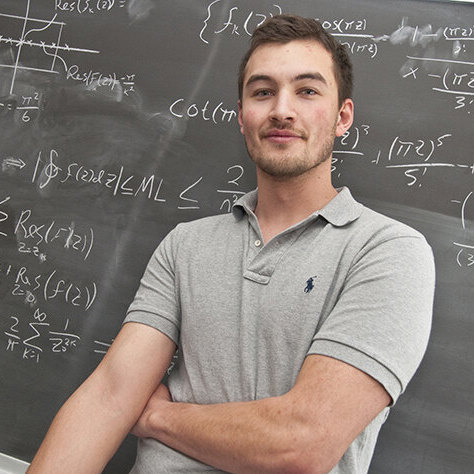 Student in front of a chalkboard