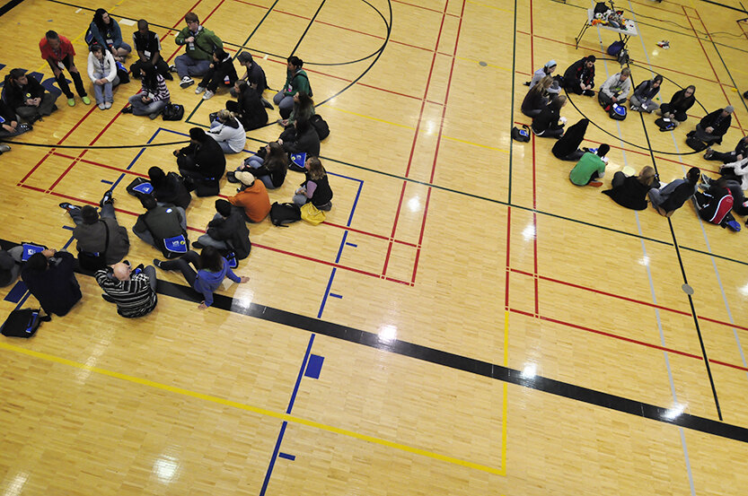Students sitting in circles inside the REC center
