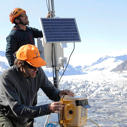 Scientists checking gauges on a glacier