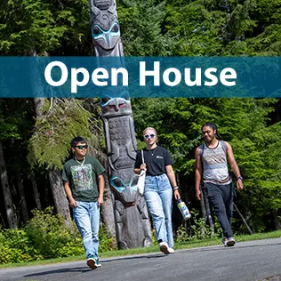 Students walking in front of a totem pole
