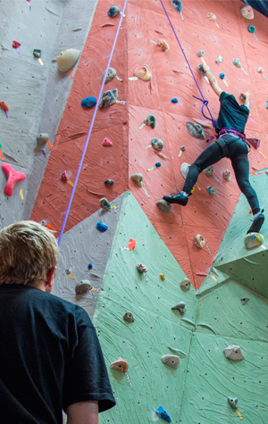 Student climbing on climbing wall